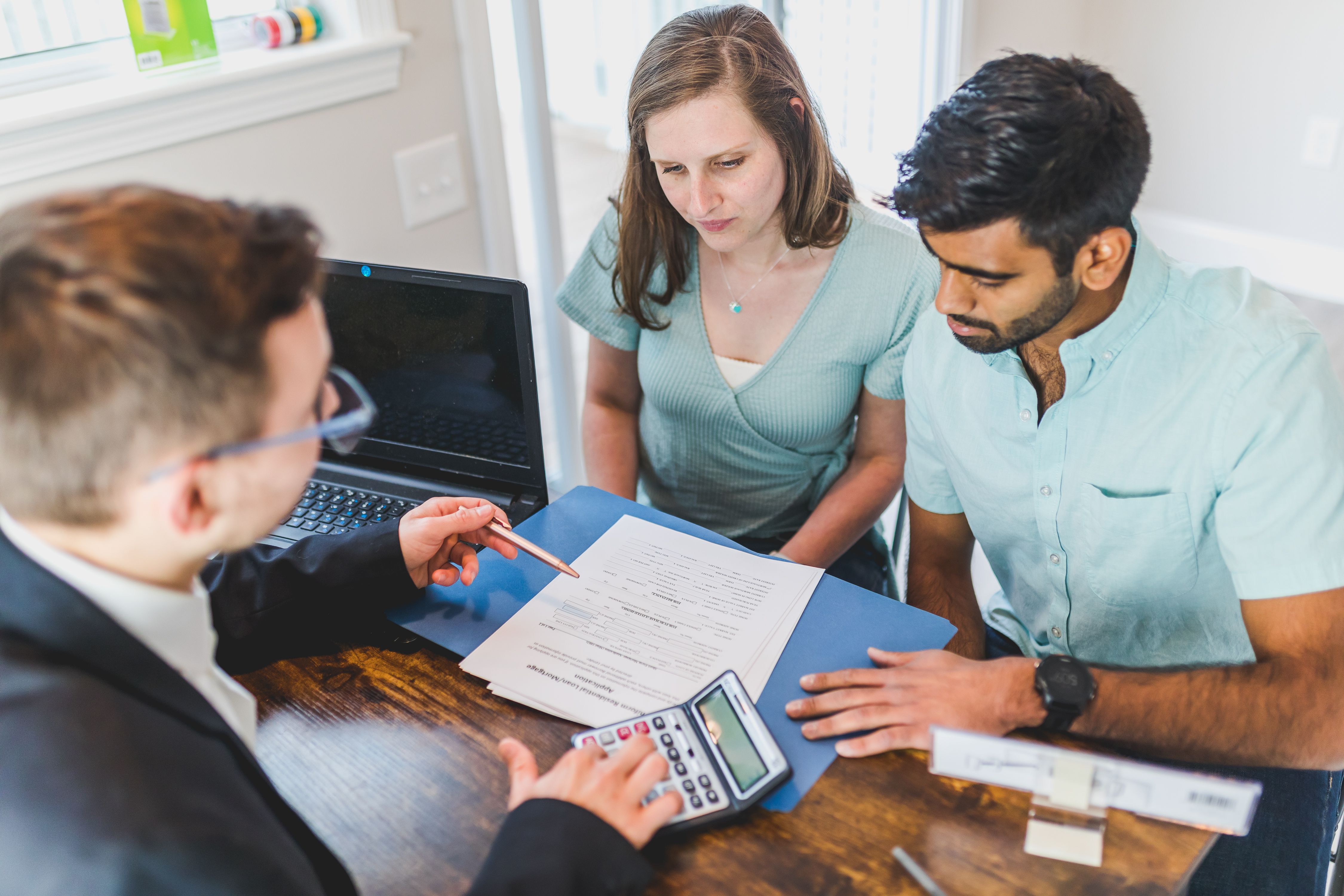 Landlords with an insurance agent meeting about home insurance